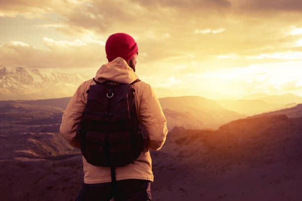 istock Hiker or traveler with backpack at sunset mountains 1176607336