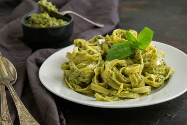 istock traditional Italian dish. pasta with pesto. on dark background. 1176609757