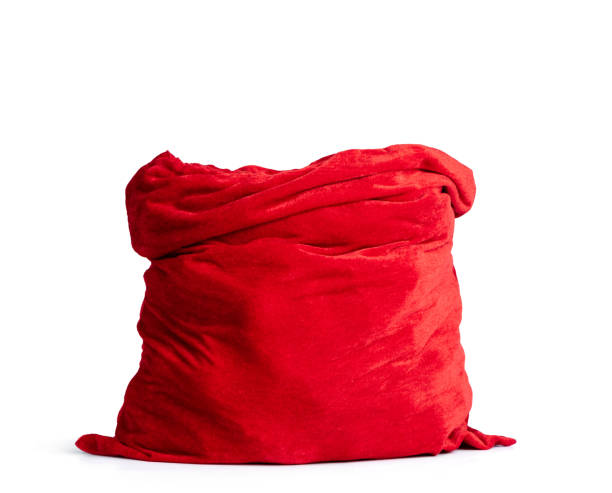 サンタクロースは、白い背景に隔離された完全な赤いバッグを開きます。ファイルには、分離へのパスが含まれています。