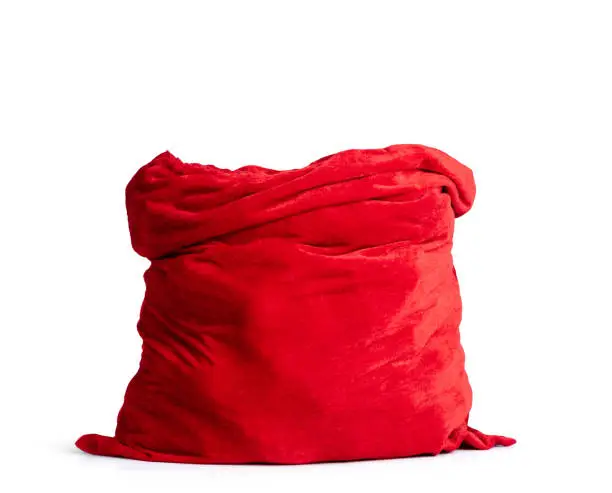 Photo of Santa Claus open red bag full, isolated on white background. File contains a path to isolation.
