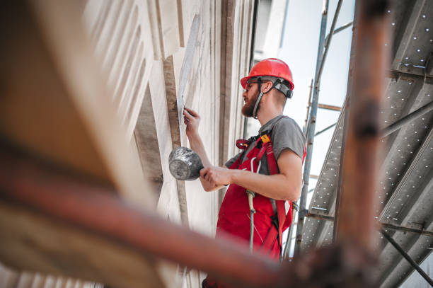 istock Male worker plastering old building wall using cement plaster mix 1176610861