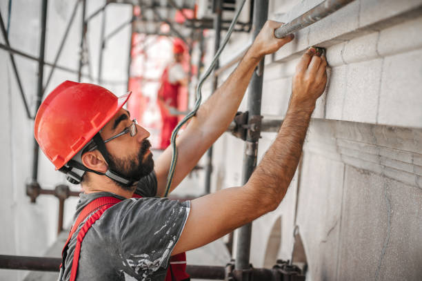 istock Man worker standing on scaffolding and restore old building facade 1176610932