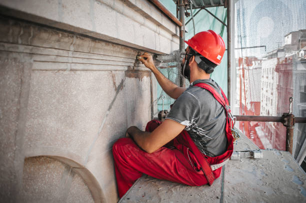 istock Male worker plastering old building wall using cement plaster mix 1176611063