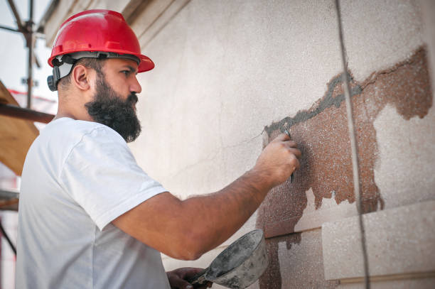 istock Male worker plastering old building wall using cement plaster mix 1176611121