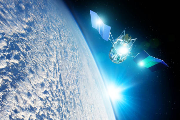 istock Space satellite orbiting the earth during sunset and bright rays lights sun reflected from solar panels. Elements of this image furnished by NASA. 1176611133