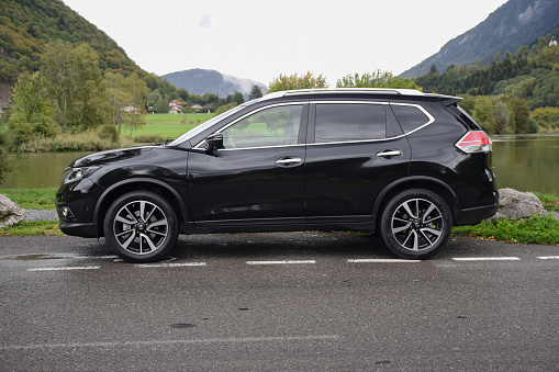 Megeve, France - September, 23th, 2015: Nissan X-Trail stopped on the road. The first geneneration of X-Trail was debut in 2001 on the market. The X-Trail is a bigger brother of Nissan Qashqai - the most popular SUV/crossover on the European market.