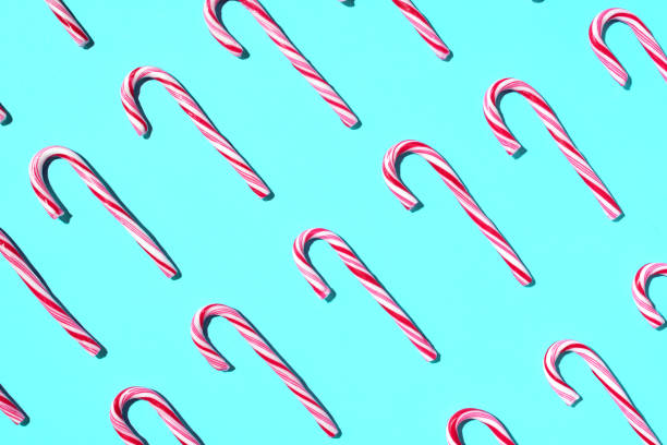 istock Pattern of Christmas candy cane on blue background. Top view. Flat lay. Creative minimal concept. Greeting card on Christmas and New Year. Art composition. 1176612463