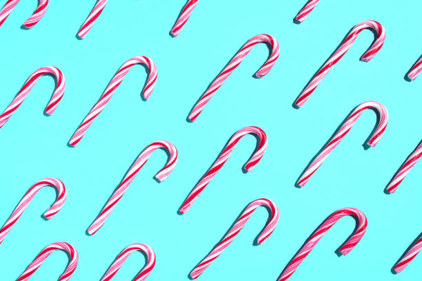 istock Pattern of Christmas candy cane on blue background. Top view. Flat lay. Creative minimal concept. Greeting card on Christmas and New Year. Art composition. 1176612478