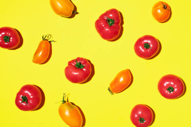 istock Yellow and red tomatoes pattern on yellow background. Flat lay, top view. Summer minimal concept. Vegan and vegetarian diet. 1176612873
