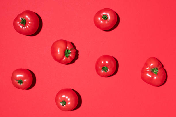 istock Red tomatoes pattern on red background. Flat lay, top view. Summer minimal concept. Vegan and vegetarian diet 1176612895