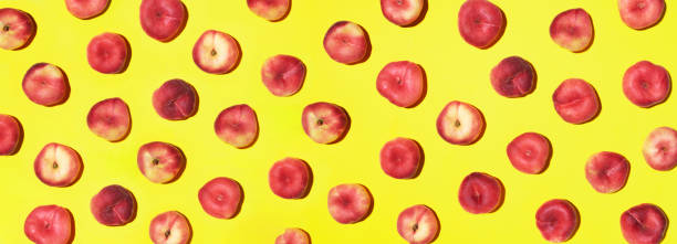 Peaches pattern on pastel yellow background. Frame made of fresh fruits. Flat lay, top view, copy space. Vegan and vegetarian diet. Banner