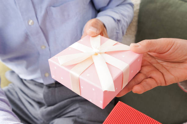 istock Senior couple giving a present 1176614542