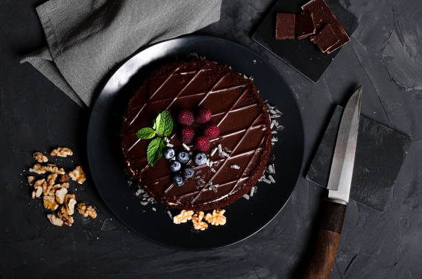 istock chocolate cake with fresh berries and nuts 1176616135