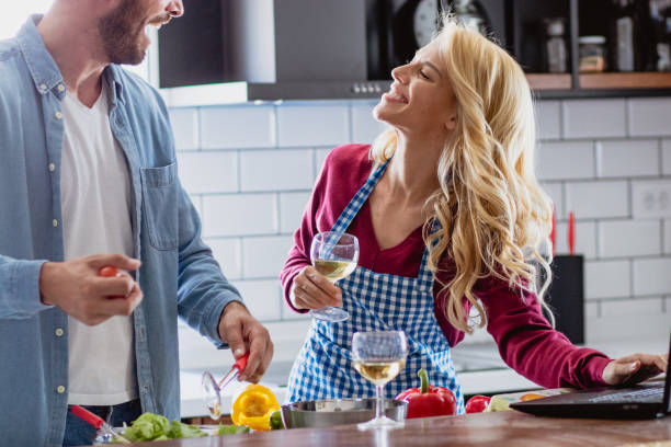 istock Young couple is preparing lunch in the kitchen using recipe from internet 1176619241