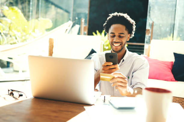 istock Young man using laptop, calculator and credit card 1176619749