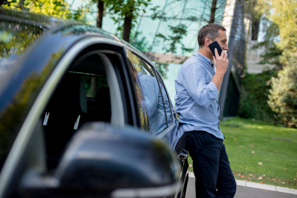 istock Casually dressed businessman using his smartphone on the parking 1176620148