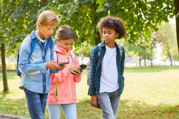 istock School children with mobile phones 1176620874