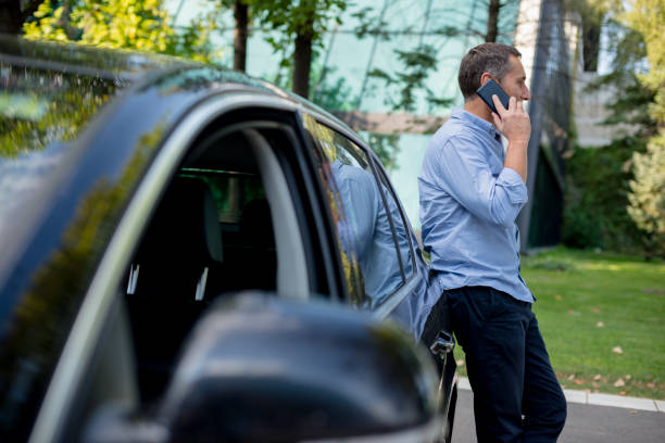 istock Casually dressed businessman using his smartphone on the parking 1176620983