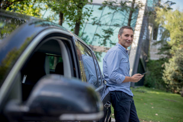 istock Casually dressed businessman using his smartphone on the parking 1176621346