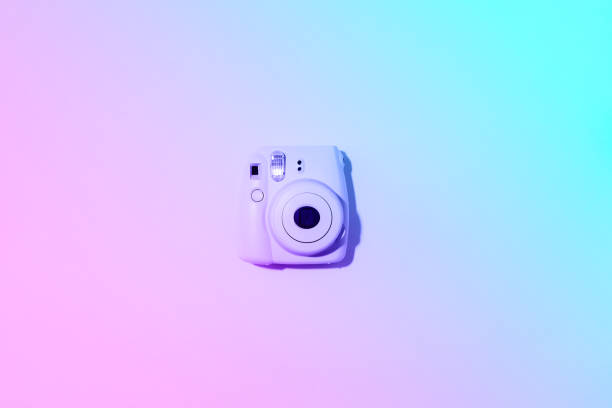 istock Vilnius, Lithuania - September 16, 2019: FUJIFILM INSTAX Mini Instant Film Camera on neon gradient background. 1176621466