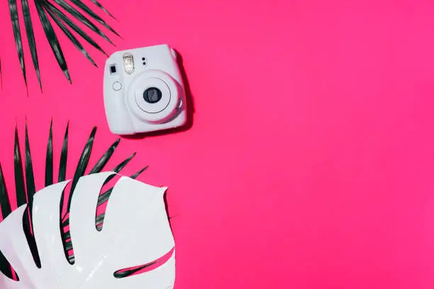 Vilnius, Lithuania - September 16, 2019: FUJIFILM INSTAX Mini Instant Film Camera on pink background