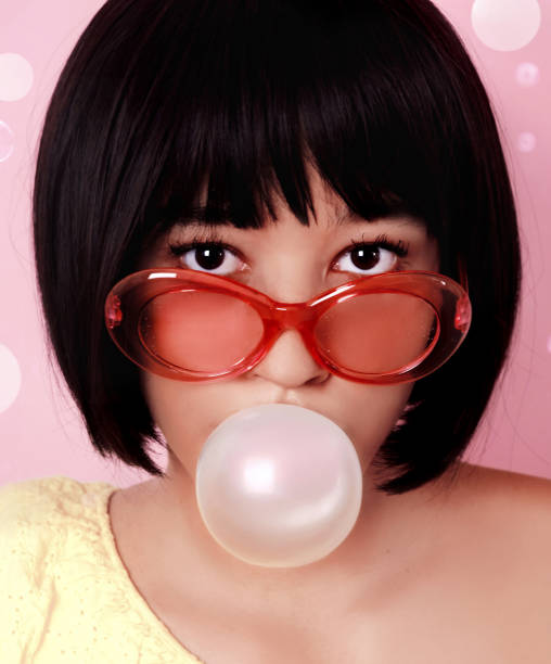 istock Woman blowing bubble gum 1176622732