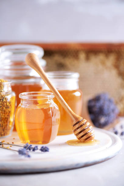 istock Bee pollen granules, honey jar with wooden dropper, honeycomb on grey backdrop. Copy space. Autumn harvest concept 1176623995