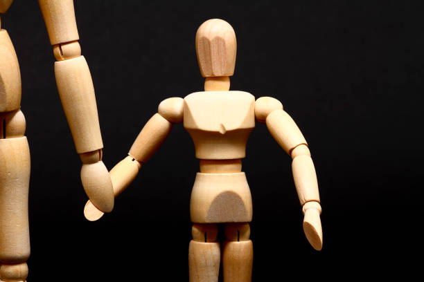 istock Manikin parent and child holding hands 1176625814
