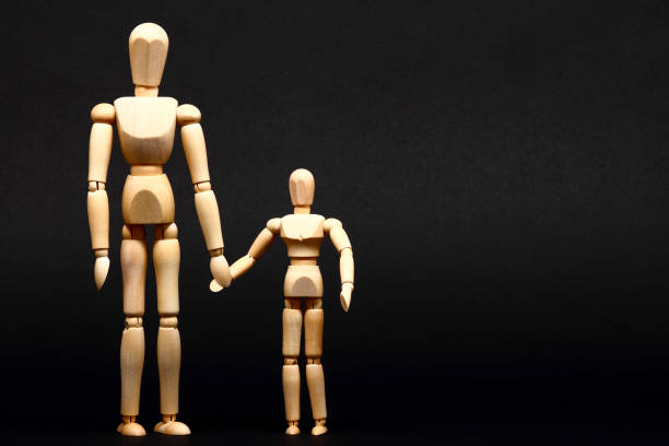 istock manikin parent and child holding hands 1176626907