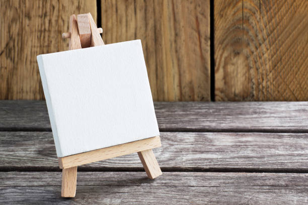istock Easel on wooden background with copy space 1176629128