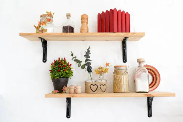 Photo of kitchen shelfs with spices, autumn white interior