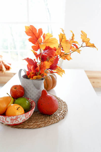 istock autumn sunny kitchen with vegetables, pumpkin and yellow leaves on white table, copy space 1176629305