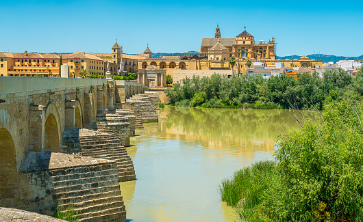 Panoramic sight in Cordoba, with the Roman Bridge and Mezquita on the Guadalquivir River. Andalusia, Spain.
