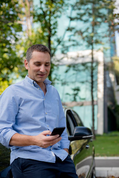 istock Handsome mid aged casually dressed guy typing on his smartphone in the street 1176632624