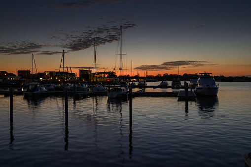 A stunning sunset over a harbour with boats at dusk. Shot in the north of Germany in a small town called Barth with the Baltic sea in the background