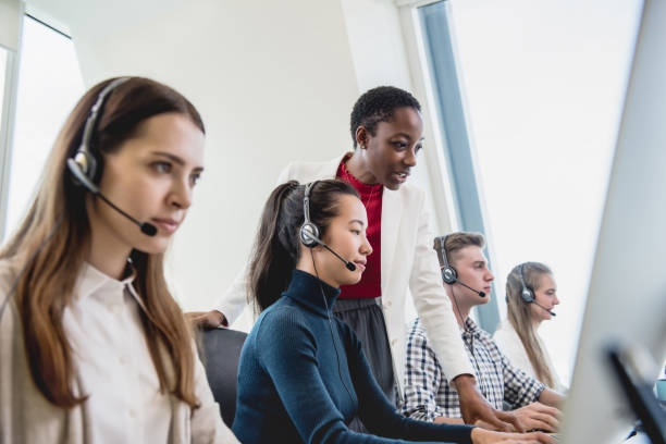 istock Female supervisor working with team in call center 1176636353
