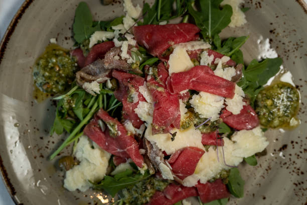 istock Plate with delicious beef carpaccio with salad 1176637618