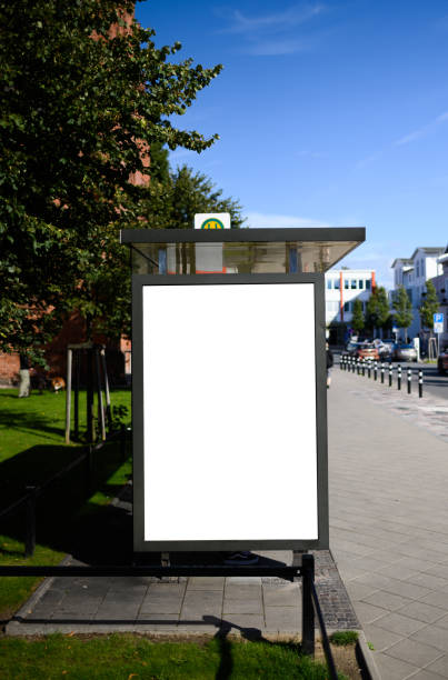Blank bus stop 6-sheet or billboard advertising template with copy space shot on a sunny day with blue sky Blank bus stop advertising poster shot in Germany near Rostock at a bus stop. Perfect for visualising design or advertising concepts bus shelter stock pictures, royalty-free photos & images