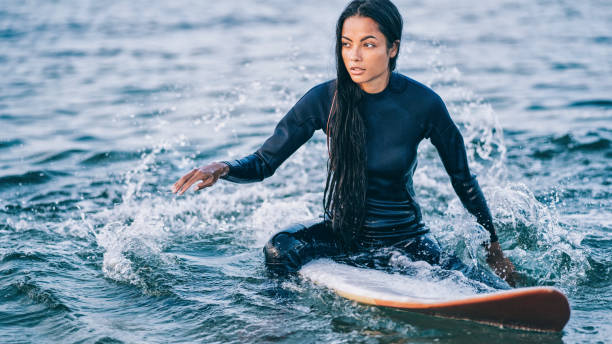 istock Asian female surfer in sea 1176638764