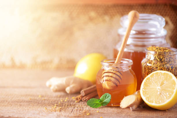 Ingredients for healthy hot drink. Lemon, ginger, mint, honey, apple and spices on wooden background. Copy space. Alternative medicine concept. Clean eating, detox Ingredients for healthy hot drink. Lemon, ginger, mint, honey, apple and spices on wooden background. Copy space. Alternative medicine concept. Clean eating, detox. ginger health stock pictures, royalty-free photos & images