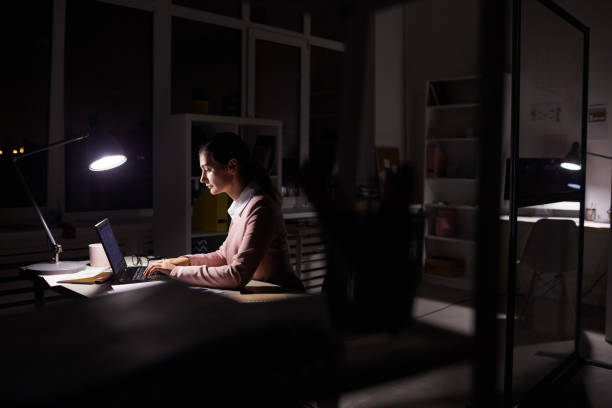 istock Businesswoman working n dark office 1176640499