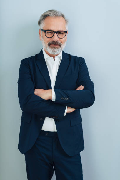 istock Mature man in blazer with arms crossed 1176644025