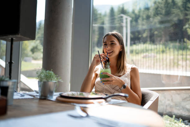 istock Beautiful woman eating pizza in restaurant 1176644099