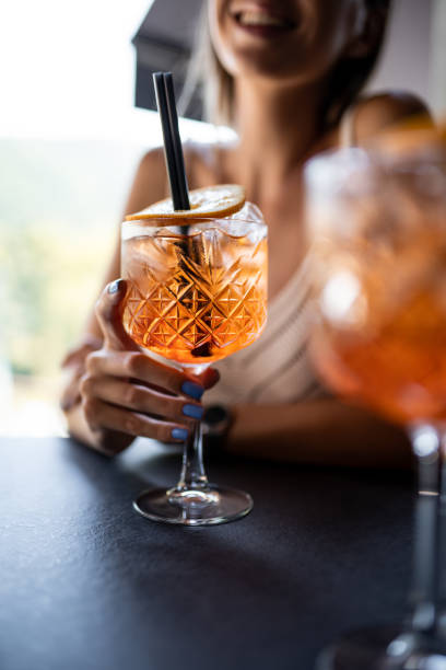 istock Beautiful woman drinking Spritz in restaurant 1176645464