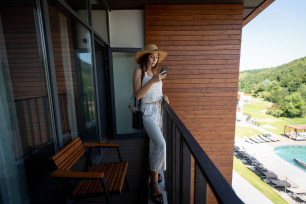 istock Woman on terrace using phone 1176645602