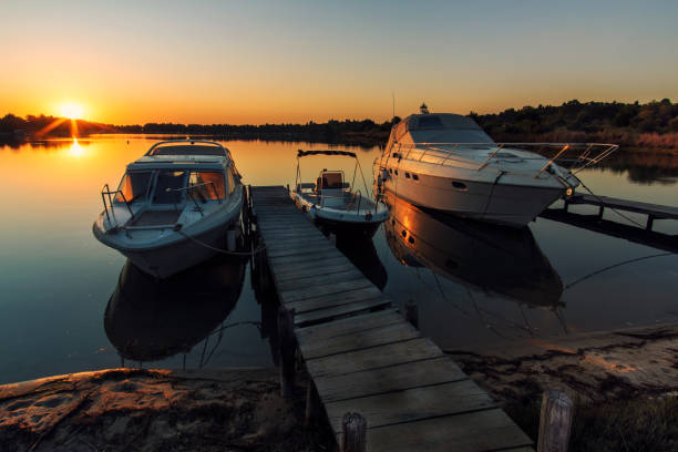 istock Boats near a pier at sunrise 1176646875
