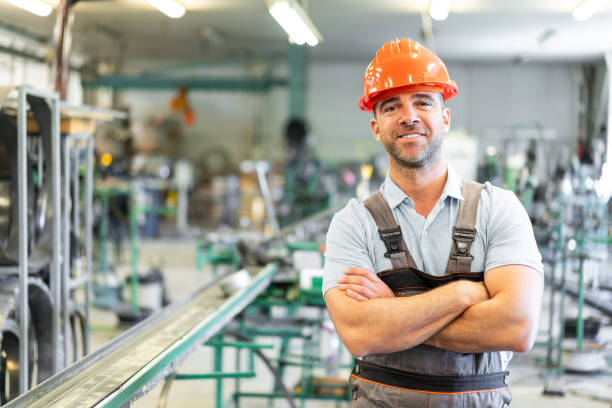 istock Foreman standing in factory with arms crossed 1176647776