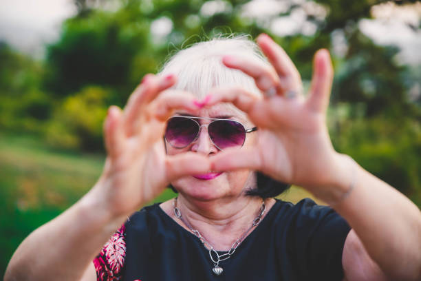 istock Senior woman making a heart shape with her hands 1176649124