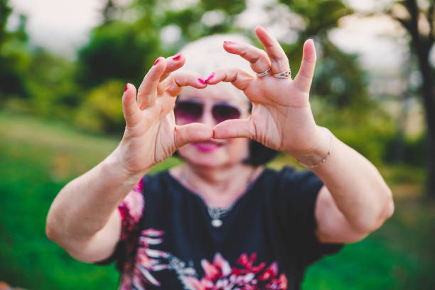 istock Senior woman making a heart shape with her hands 1176649150