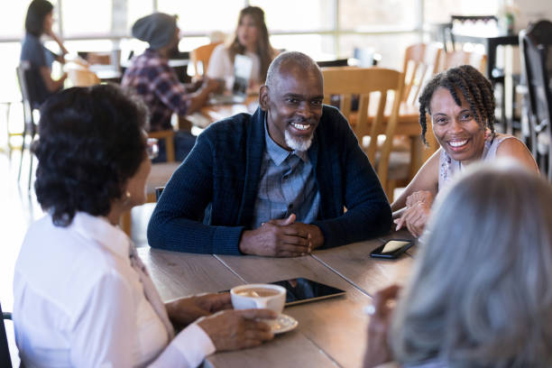 istock Group of active seniors enjoy conversation over coffee at cafe 1176649323